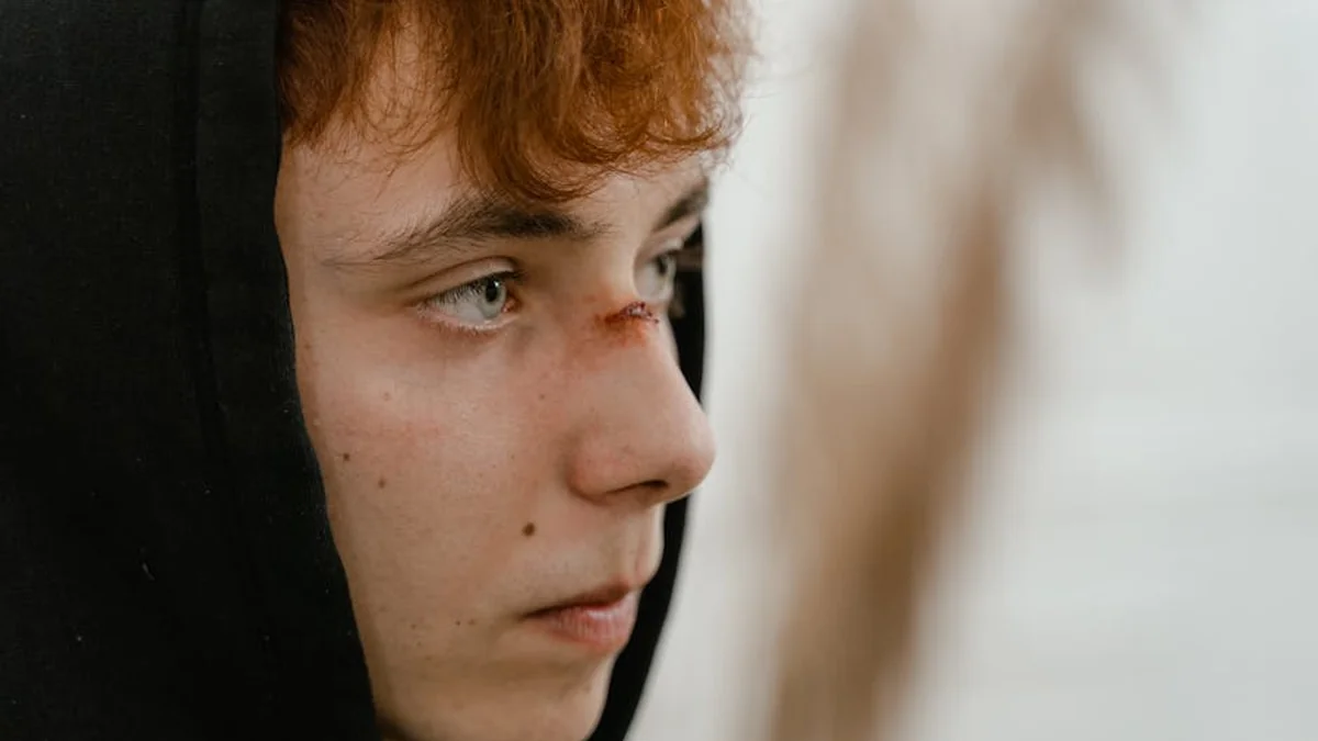His father beat him up and locked him in, he escaped through the balcony in front of them